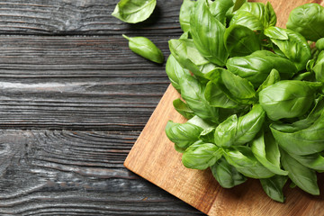 Fresh green basil on black wooden table, flat lay