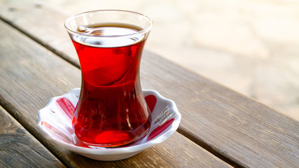 turkish black tea in a glass on wooden table