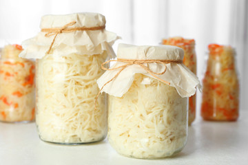 Tasty homemade fermented cabbage on white table
