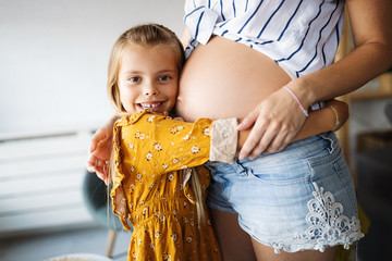 Happy family, togetherness, love. Beautiful pregnant mother with cute child