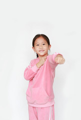 Portrait of beautiful little Asian child girl in pink tracksuit or sport cloth with fight stance over white background. Portrait half-length of kid girl. Confident concept.