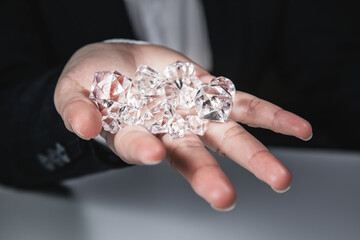 Businessman jeweler during the evaluation of jewels . Businessman showing the diamonds or Luxury stone through loupe evaluating gem a symbol of business success or successful finance concept