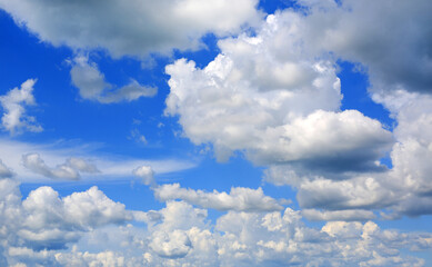 Blue sky and fluffy clouds background.
