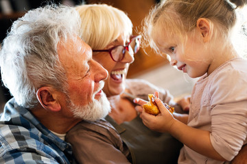 Grandparents playing and having fun with their granddaughter