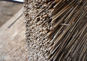 The reed roof on the house. Natural building materials.    