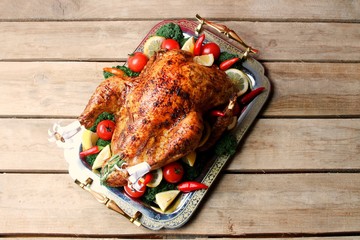 Roasted Turkey For Thanksgiving Or Christmas On Tray With Vegetables On Wooden Background.