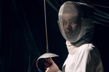 Fencer woman with fencing sword.