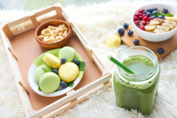 matcha green tea, breakfast top view white background. oatmeal with berries, toasts on a wooden tray, nuts, coffee