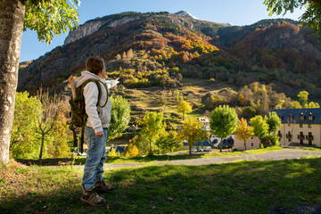 smiling boy with backpack in autumn mountains