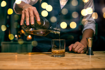 bartender pouring beer in glass