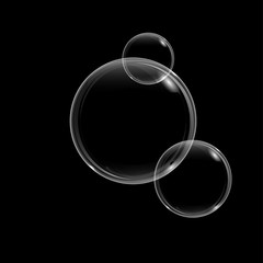 Soap bubble with rainbow reflection on black background. Transparent foam bubble, great design for any purposes.