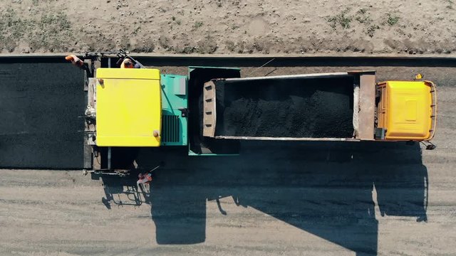 Road makers are laying asphalt on the road