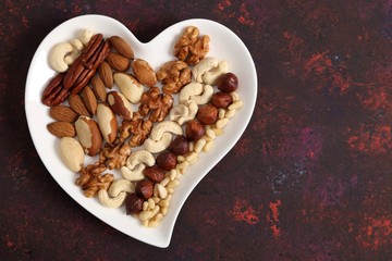 Nuts on a plate in the shape of a heart.