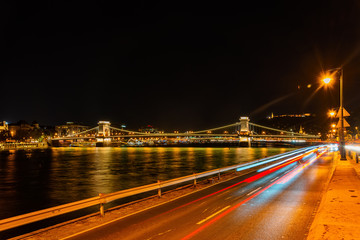 Fototapeta na wymiar Budapest, Hungary-October 01, 2019: A night view of Szechenyi Chain Bridge over the Danube River in Budapest. It is the oldest and most famous road bridge in Budapest. Panorama of Budapest.