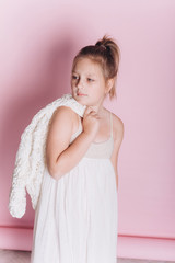 Close up portrait of young caucasian pretty stylish model posing in studio with sensual face on soft pink background. Beauty, emotional, natural beauty concept