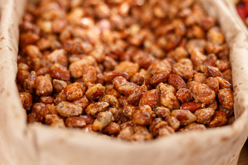 Roasted almond nuts in panning, close up, selective focus