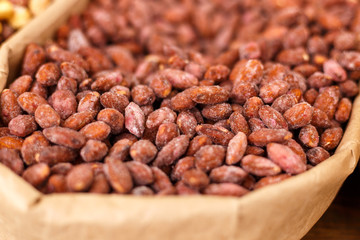 Roasted almond nuts in panning, close up, selective focus