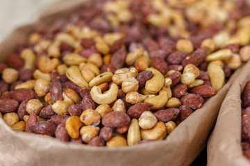 Peanuts, walnuts, almonds, hazelnuts and cashews mixed together, close up, selective focus