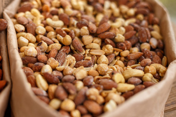 Peanuts, walnuts, almonds, hazelnuts and cashews mixed together, close up, selective focus