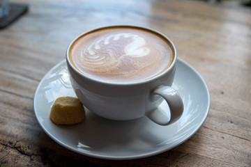 coffee in a cup and a biscuit