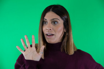 Surprised woman with straight hair looking at camera and chroma background