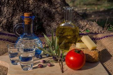 Cretan food with virgin olive oil, Olives,Cretan Barley Rusks, local cheese and carafe of cretan...