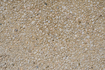 Wall with small stones. Texture.