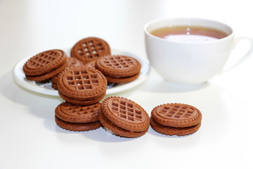 Fototapeta na wymiar Cookies with chocolate. White cup with black tea. Tea ceremony. Sweet morning. Still life.