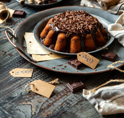 homemade chocolate cake with melted chocolate and chocolate flakes
