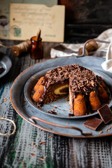 homemade sliced chocolate cake with melted chocolate and chocolate flakes