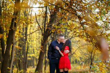 Fototapeta premium Beautiful couple in the autumn forest