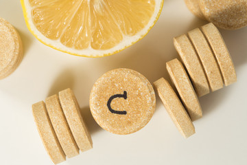 Top view of vitamin c pills and lemon slice