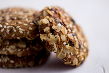 close up homemade backed cereal oat cookie on white background. macro healthy food photography