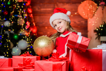 Christmas gift for you. Happy little girl giving new year gift. Small child holding gift box on boxing day. Adorable kid with beautifully wrapped Christmas gift. Wrapping it up very nicely