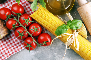 Pasta, vegetables, herbs and spices for Italian food on rustic table
