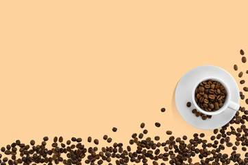 A white cup filled with freshly roasted coffee beans on a light beige background. Coffee time. Flat lay, top view. Copy space