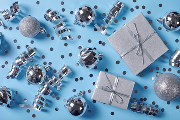Gift boxes with christmas balls on blue bsckground.