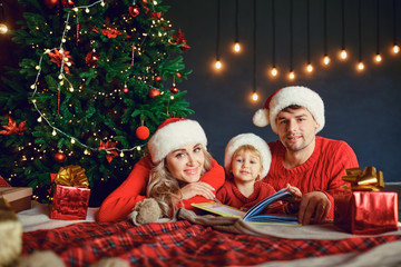 Happy family at home with christmas tree