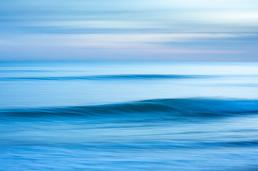 A dreamy blue blurred effect abstract of the sea at sunset created by using a slow shutter speed. Taken at Brighton, East Sussex.