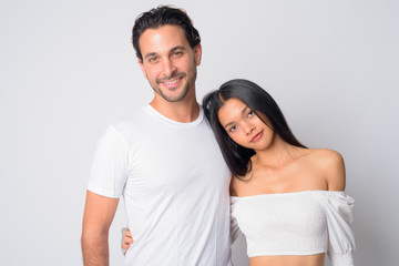 Fototapeta premium Portrait of happy multi ethnic couple hugging each other
