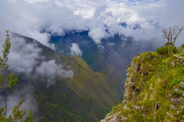 Panoramic view from Machu Picchu Mountain onto mountains and valleys and ruins of lost city of Inka...