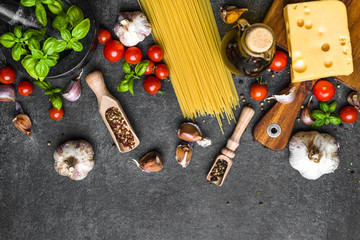 Fototapeta na wymiar Italian food background. Cooking ingredients for spaghetti: tomatoes, basil, olive oil, cheese, garlic, spices