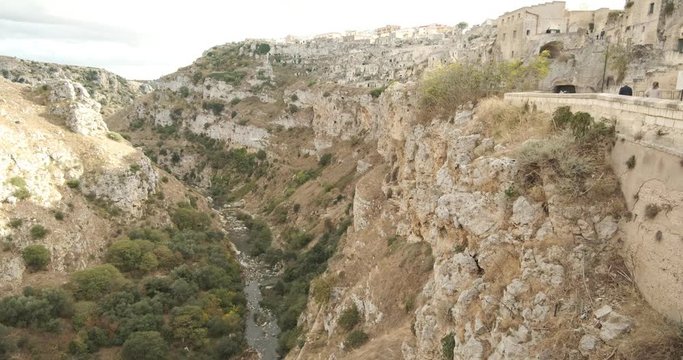 Sassi of Matera with houses dug out of the tuff rock. Torrent and mountain with the ancient city.