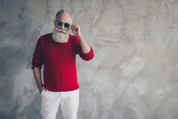 Portrait of trendy stylish gorgeous old man have red modern jumper white pants trousers feel...