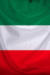 beautiful colored photograph of the beautiful colored national flag of the modern state of Italy on textured fabric, concept of tourism, emigration, economics and politics, closeup, vertical