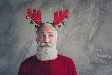 Portrait of stylish funky old man in reindeer headband enjoy christmas party x-mas celebration wear...