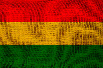 beautiful colored national flag of bolivia state on fabric canvas, burlap, closeup, concept of tourism, economy and politics
