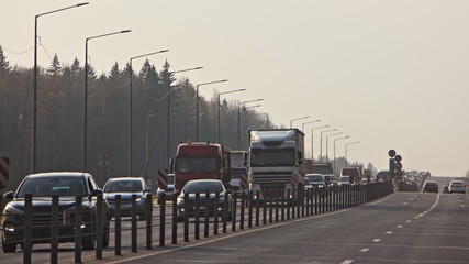 Obraz premium Traffic jam - a lot of cars on the highway on a autumn day at rush hour, delay