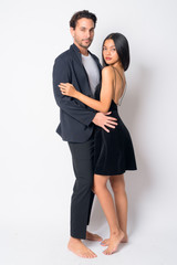 Full body shot of multi ethnic business couple hugging each other