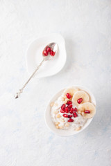 Oatmeal and yogurt smoothie with pomegranate, banana and pine nuts